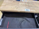 a wooden table with a drawer underneath it in a store