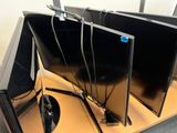 three televisions that are sitting on a table