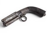 an old gun that is on a white surface
