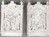 two white statues of jesus and mary with a cross on them