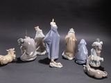 many figurines of different sizes and colors on the table