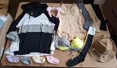 a box with clothes and a hat on top of it