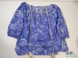 a blue blouse with a gold chain on it
