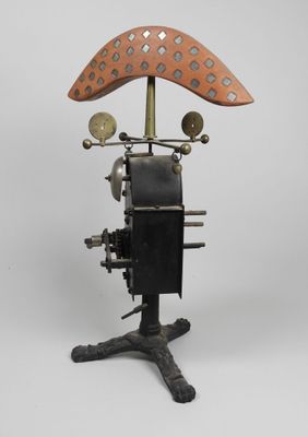 an old fashioned steam engine with a wooden seat on a metal stand