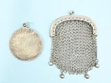 a close up of a coin and a purse on a blue surface