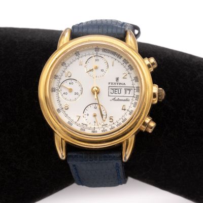 a close up of a gold watch on a black cloth