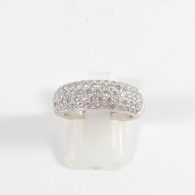 a close up of a diamond ring on a white surface