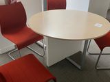 four chairs around a round table in a room