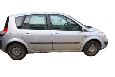 a small silver car that is parked on the side of the road