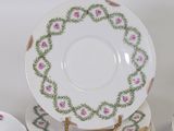 a stack of plates and cups on a table
