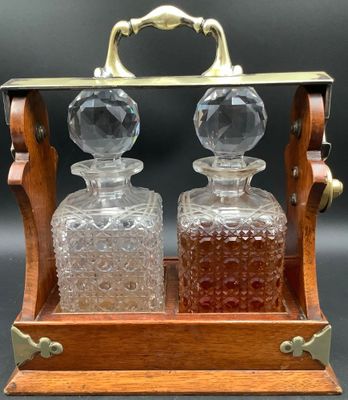 an old fashioned glass decanter set with a wooden stand