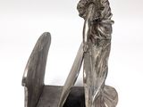 statue of a woman with a sword and shield on a bookend