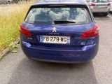 a blue car that is parked on the side of the road