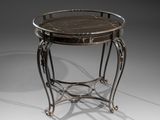 a round metal table with a marble top on a stand