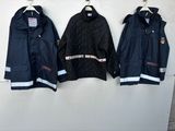 three jackets hanging on a wall next to each other