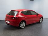 the rear end of a red car parked in a garage