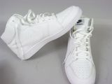 pair of white nike sneakers with white laces on a white surface