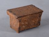 an old wooden box sitting on top of a gray surface