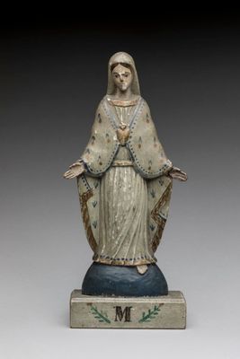 statue of the virgin of guadalupe, made of wood and painted in blue and white
