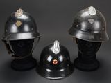 three helmets are sitting on top of each other on a black surface