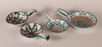several different types of bowls and spoons on a white surface