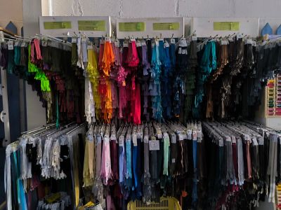 a large rack of clothing in a store with lots of clothes