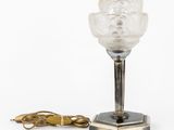 an art deco table lamp with a glass shade and a metal base