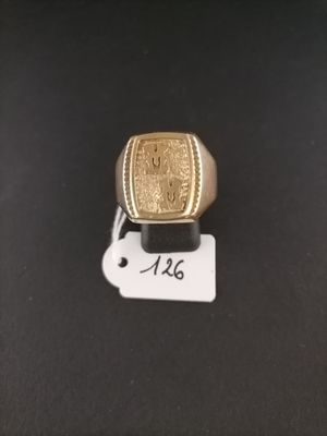 a close up of a gold ring on a black surface