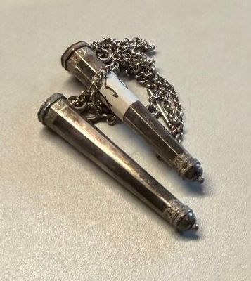 two lighters sitting on a table with a chain around them