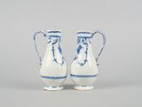 pair of blue and white vases on a gray surface