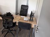 a desk with a chair and a computer on it