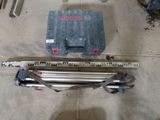 a picture of a tool box and a tripod in a garage