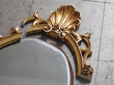 a mirror that is sitting on the floor next to a wall