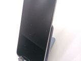 a cell phone that is sitting on top of a stand