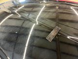 a remote control sitting on the hood of a car