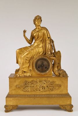 an image of a gold statue of a woman sitting on top of a clock