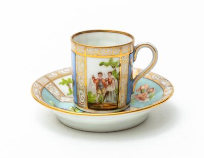 a cup and saucer with a picture of a couple on it