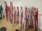 a lot of skis that are lined up against a wall