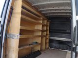 the back of a van with shelves in the back of it
