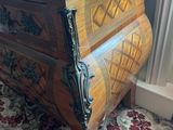 a wooden chest of drawers in a living room