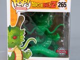 a green dragon figurine in a box on a table