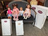 four dolls sitting on a bench in a store