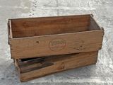 a wooden box that is sitting on the ground