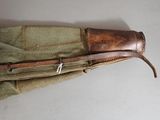 a brown bag with a leather handle on a white table