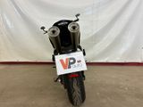 a motorcycle parked in a garage with a sign on the back of it