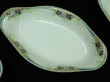 three plates with floral designs are arranged on a black surface
