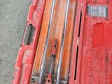 a red tool box with tools in it on the floor