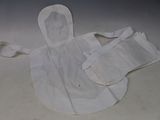 a white apron and bib laying on a table