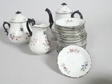 a group of dishes and cups that are sitting on a table