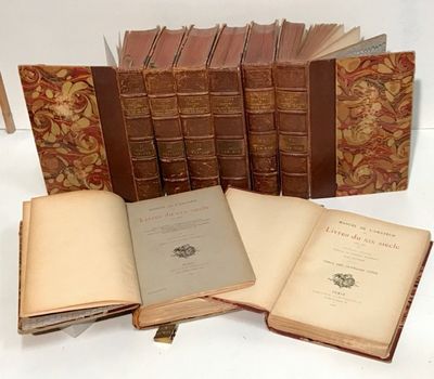 several old books are stacked on top of each other on a table